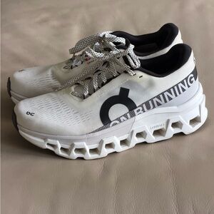 On Running Cloudmonster Black and White Sneakers